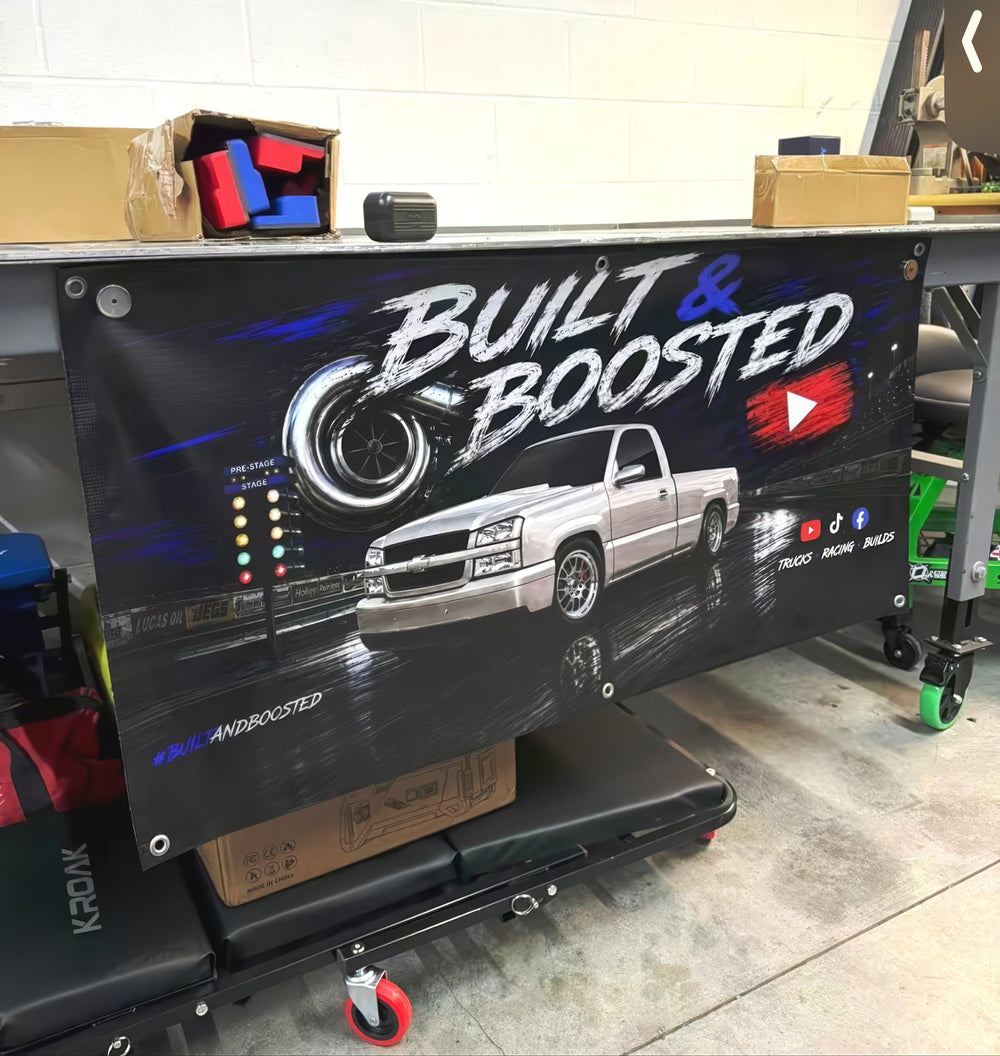 Built & Boosted automotive banner in a garage